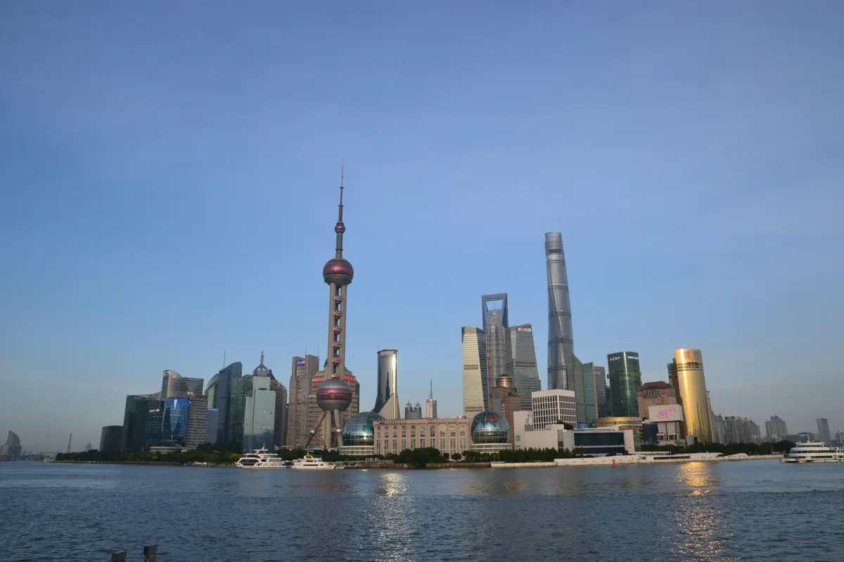 Shanghai skyline at dusk with illuminated Pudong towers